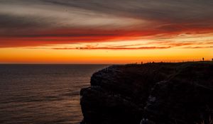 Preview wallpaper sea, rock, sunset, sky, dark, nature