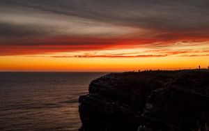 Preview wallpaper sea, rock, sunset, sky, dark, nature