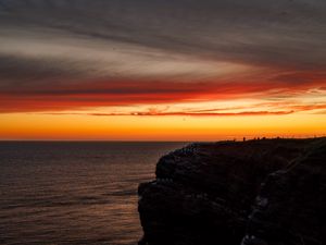 Preview wallpaper sea, rock, sunset, sky, dark, nature