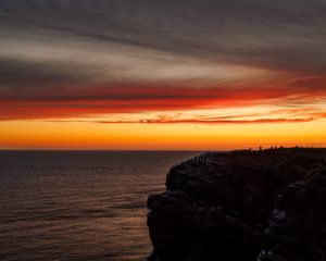 Preview wallpaper sea, rock, sunset, sky, dark, nature