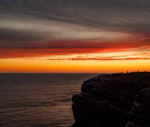 Preview wallpaper sea, rock, sunset, sky, dark, nature