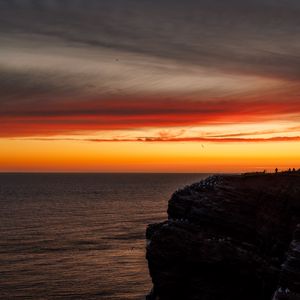 Preview wallpaper sea, rock, sunset, sky, dark, nature