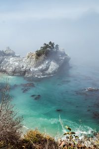 Preview wallpaper sea, rock, trees, fog, nature