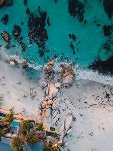 Preview wallpaper sea, rocks, beach, buildings, palm trees, aerial view