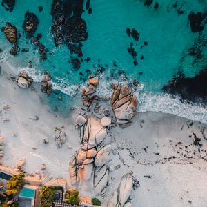 Preview wallpaper sea, rocks, beach, buildings, palm trees, aerial view