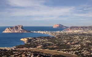 Preview wallpaper sea, rocks, city, buildings, aerial view