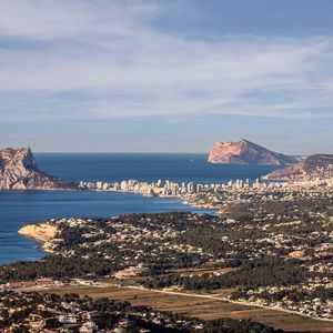 Preview wallpaper sea, rocks, city, buildings, aerial view