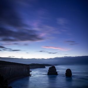 Preview wallpaper sea, rocks, cliff, twilight, landscape