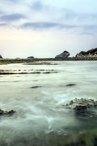 Preview wallpaper sea, rocks, coast, reeves, bank, fog, cloudy, colors