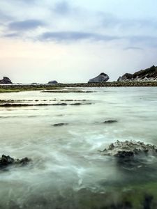 Preview wallpaper sea, rocks, coast, reeves, bank, fog, cloudy, colors