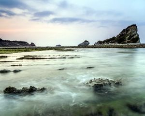 Preview wallpaper sea, rocks, coast, reeves, bank, fog, cloudy, colors