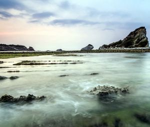 Preview wallpaper sea, rocks, coast, reeves, bank, fog, cloudy, colors