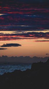 Preview wallpaper sea, rocks, dusk, horizon, clouds