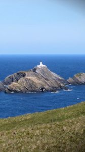 Preview wallpaper sea, rocks, lighthouse, sky, coast, landscape