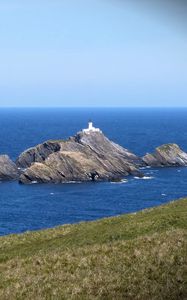 Preview wallpaper sea, rocks, lighthouse, sky, coast, landscape