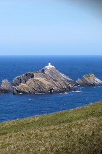 Preview wallpaper sea, rocks, lighthouse, sky, coast, landscape