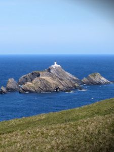 Preview wallpaper sea, rocks, lighthouse, sky, coast, landscape