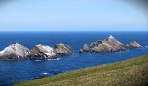 Preview wallpaper sea, rocks, lighthouse, sky, coast, landscape