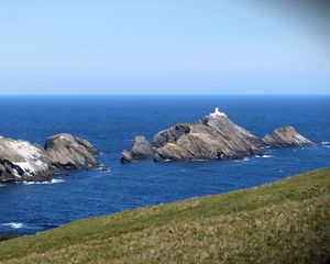 Preview wallpaper sea, rocks, lighthouse, sky, coast, landscape