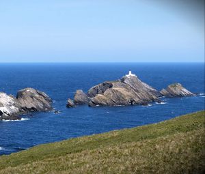 Preview wallpaper sea, rocks, lighthouse, sky, coast, landscape