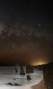 Preview wallpaper sea, rocks, stars, starry sky, dark