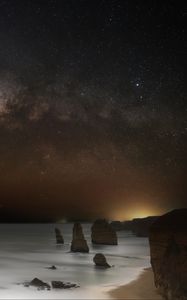 Preview wallpaper sea, rocks, stars, starry sky, dark