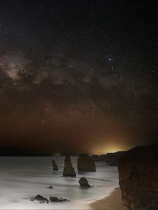 Preview wallpaper sea, rocks, stars, starry sky, dark