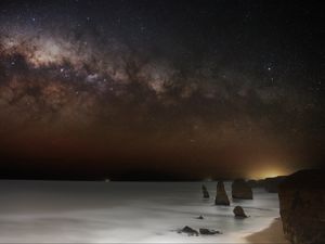 Preview wallpaper sea, rocks, stars, starry sky, dark