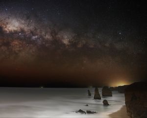 Preview wallpaper sea, rocks, stars, starry sky, dark