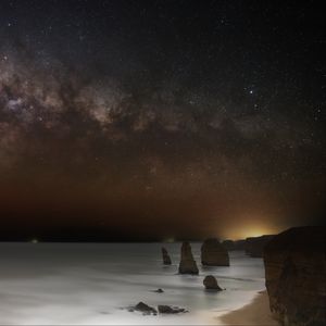 Preview wallpaper sea, rocks, stars, starry sky, dark