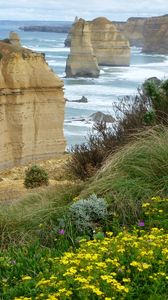 Preview wallpaper sea, rocks, stones, grass, flowers