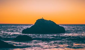 Preview wallpaper sea, rocks, sunset, dusk, waves