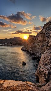 Preview wallpaper sea, rocks, sunset, coast, evening, landscape