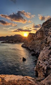 Preview wallpaper sea, rocks, sunset, coast, evening, landscape