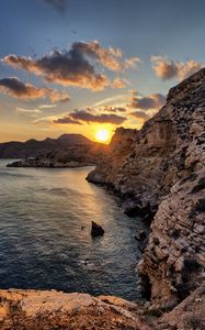 Preview wallpaper sea, rocks, sunset, coast, evening, landscape