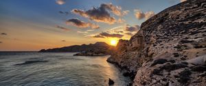 Preview wallpaper sea, rocks, sunset, coast, evening, landscape