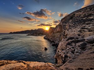 Preview wallpaper sea, rocks, sunset, coast, evening, landscape