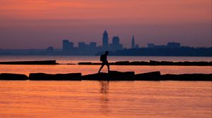 Preview wallpaper sea, silhouettes, pier, city, dark