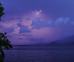 Preview wallpaper sea, sky, lightning, mountains, landscape, nature