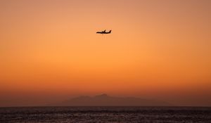 Preview wallpaper sea, sky, plane, island, dusk