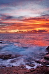 Preview wallpaper sea, sky, sunset, clouds, rocks, surf