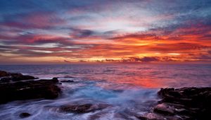 Preview wallpaper sea, sky, sunset, clouds, rocks, surf