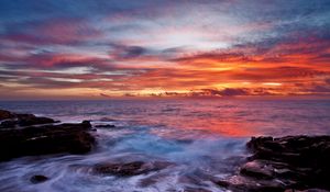 Preview wallpaper sea, sky, sunset, clouds, rocks, surf