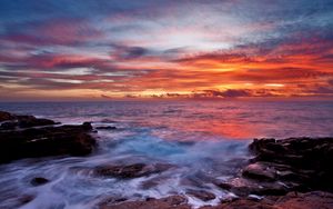 Preview wallpaper sea, sky, sunset, clouds, rocks, surf