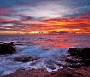 Preview wallpaper sea, sky, sunset, clouds, rocks, surf