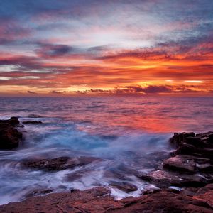 Preview wallpaper sea, sky, sunset, clouds, rocks, surf