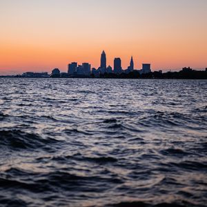 Preview wallpaper sea, skyscrapers, buildings, silhouettes, twilight, city