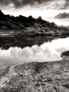 Preview wallpaper sea, stones, coast, rocks, despondency, black-and-white