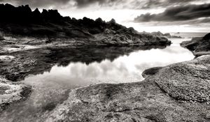 Preview wallpaper sea, stones, coast, rocks, despondency, black-and-white