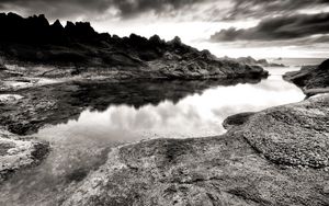 Preview wallpaper sea, stones, coast, rocks, despondency, black-and-white